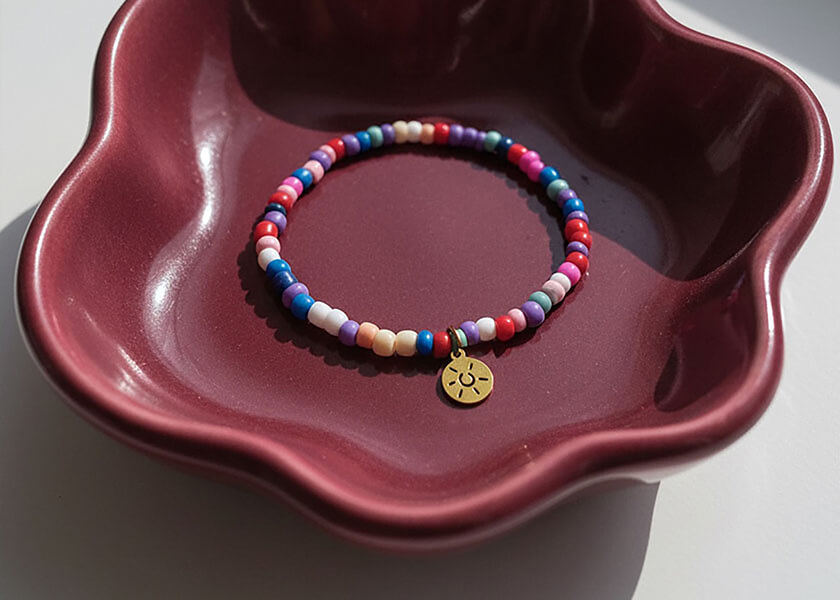 Perlenarmband mit personalisiertem Logo-Anhänger als individuell gefertigtes Werbegeschenk