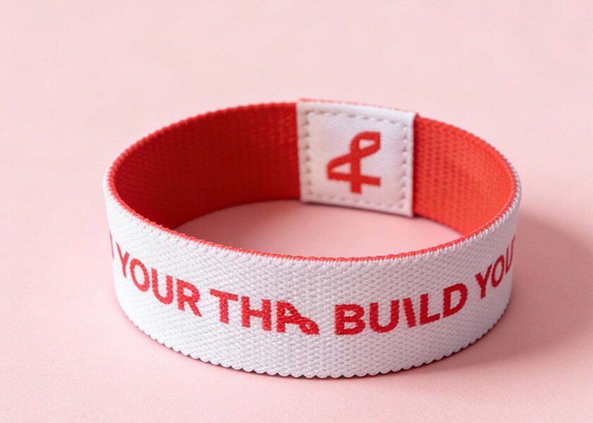 Rosa flexibles Wendearmband mit Logo- und Motivdruck als individuell gestaltetes Promoarmband